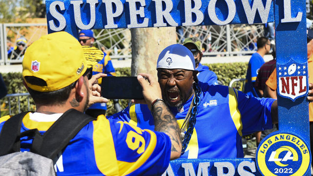 TOPSHOT - Fans celebrate outside of the Los Angeles Memorial Coliseum during the Rams NFL Super Bowl LVI victory parade in Los Angeles, California, on February 16, 2022.