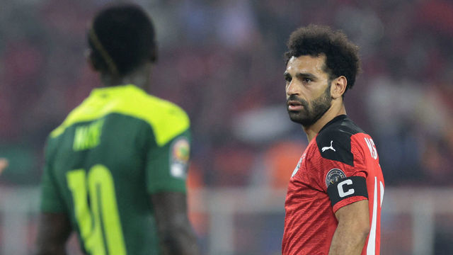 Egypt's forward Mohamed Salah (R) and Senegal's forward Sadio Mane look on during the Africa Cup of Nations (CAN) 2021 final football match between Senegal and Egypt at Stade d'Olembe in Yaounde on February 6, 2022.