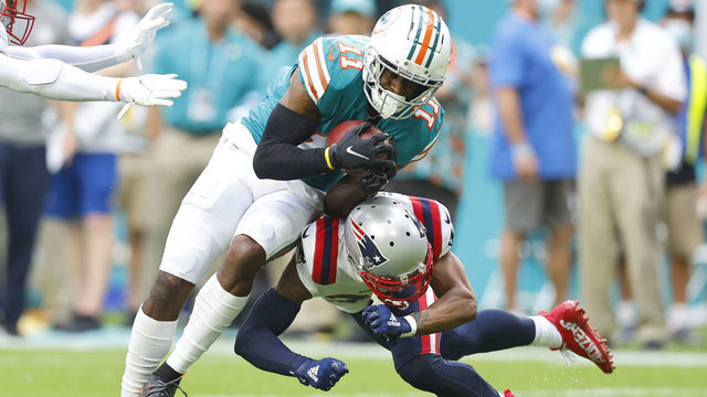 MIAMI GARDENS, FLORIDA - JANUARY 09: J.C. Jackson #27 of the New England Patriots tackles DeVante Parker #11 of the Miami Dolphins during the first quarter at Hard Rock Stadium on January 09, 2022 in Miami Gardens, Florida.