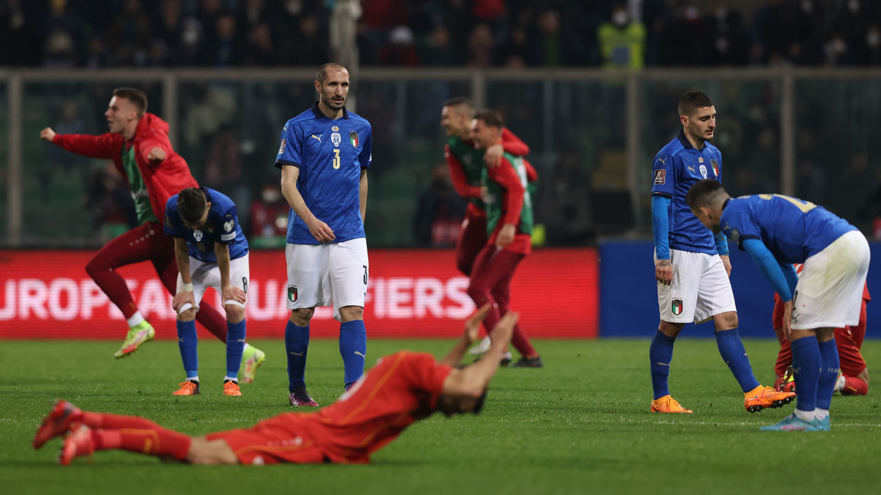 PALERMO, ITALY - MARCH 24: Giorgio Chiellini, Marco Verratti and Giacomo Raspadori of Italy react as North Macedonia players celebrate at the final whistle of the 2022 FIFA World Cup Qualifier knockout round play-off match between Italy and North Macedonia at Stadio Renzo Barbera on March 24, 2022 in Palermo, Italy.