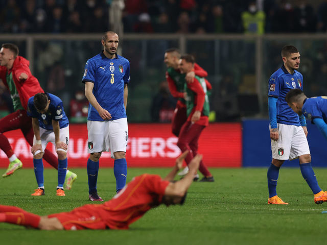 PALERMO, ITALY - MARCH 24: Giorgio Chiellini, Marco Verratti and Giacomo Raspadori of Italy react as North Macedonia players celebrate at the final whistle of the 2022 FIFA World Cup Qualifier knockout round play-off match between Italy and North Macedonia at Stadio Renzo Barbera on March 24, 2022 in Palermo, Italy.
