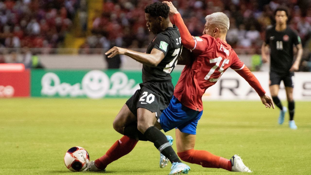 Costa Rica's Francisco Calvo (R) vies for the ball with Canada´s Jonathan David during their FIFA World Cup Qatar 2022 Concacaf qualifier match at the National Stadium in San Jose, on March 24, 2022.