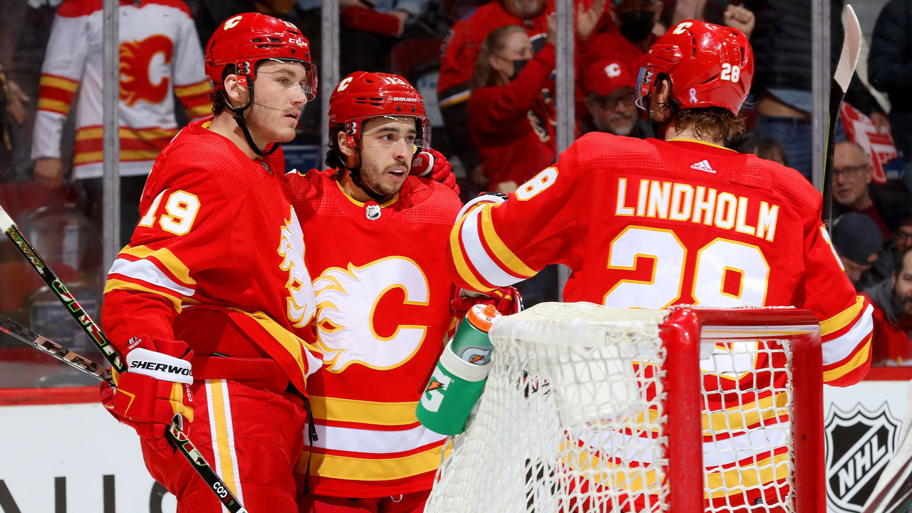 CALGARY, ALBERTA - MARCH 25: Johnny Gaudreau #13, Matthew Tkachuk #19 of the Calgary Flames celebrate a goal against the Arizona Coyotes at Scotiabank Saddledome on March 25, 2022 in Calgary, Alberta.