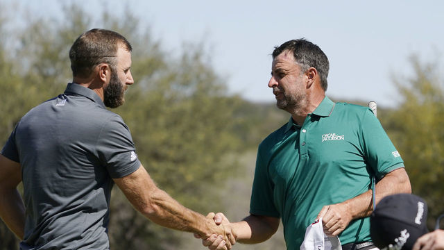 AUSTIN, TEXAS - MARCH 26: Dustin Johnson of the United States shakes hands with Richard Bland of England after defeating him 3&2 on the 16th green in their Round of 16 match on the fourth day of the World Golf Championships-Dell Technologies Match Play at Austin Country Club on March 26, 2022 in Austin, Texas.