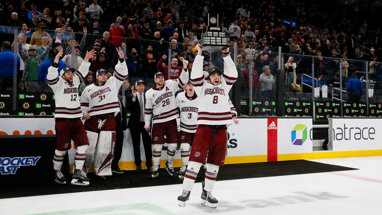 BOSTON, MA - MARCH 19: Bobby Trivigno #8 of the Massachusetts Minutemen raises the Lou Lamoriello Trophy after a 2-1 overtime victory against the Connecticut Huskies during NCAA men's hockey in the Hockey East Championship Final at TD Garden on March 19, 2022 in Boston, Massachusetts. This is the second consecutive Hockey East Championship for the Minutemen.