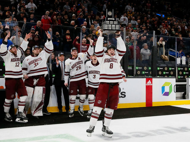 BOSTON, MA - MARCH 19: Bobby Trivigno #8 of the Massachusetts Minutemen raises the Lou Lamoriello Trophy after a 2-1 overtime victory against the Connecticut Huskies during NCAA men's hockey in the Hockey East Championship Final at TD Garden on March 19, 2022 in Boston, Massachusetts. This is the second consecutive Hockey East Championship for the Minutemen.