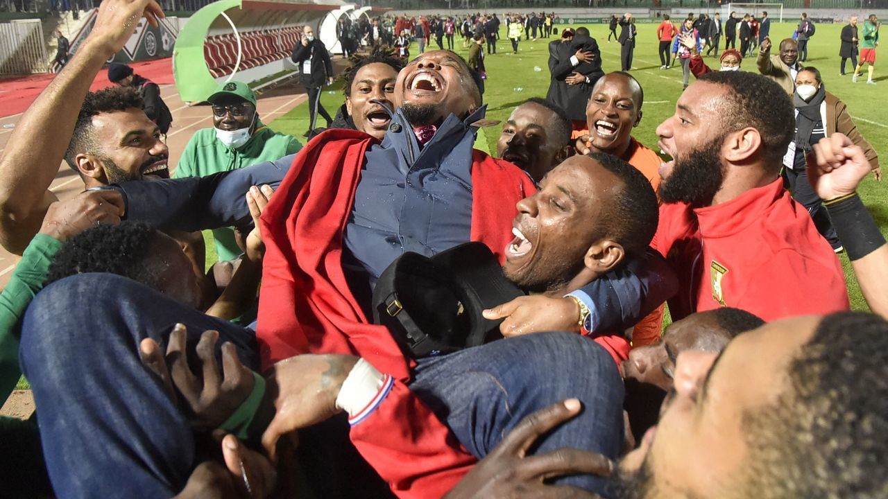 Cameroon's players celebrate with Samuel Eto'o, president of the Cameroonian Football Federation, after qualifying to the 2022 Qatar World Cup African Qualifiers football match between Algeria and Cameroon at the Mustapha Tchaker Stadium in the city of Blida on March 29, 2022.