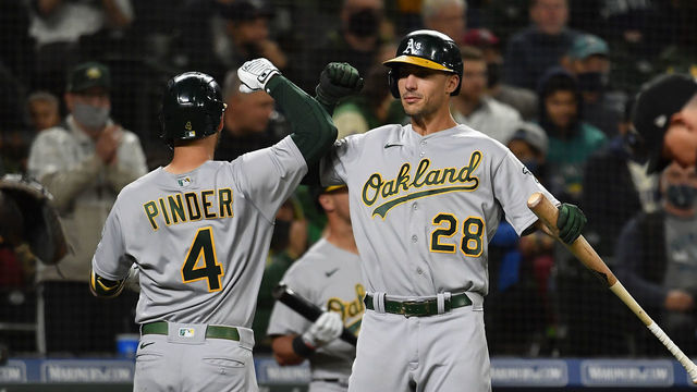 SEATTLE, WASHINGTON - SEPTEMBER 28: Chad Pinder #4 of the Oakland Athletics celebrates with Matt Olson #28 after hitting a home run during the fourth inning against the Seattle Mariners at T-Mobile Park on September 28, 2021 in Seattle, Washington.