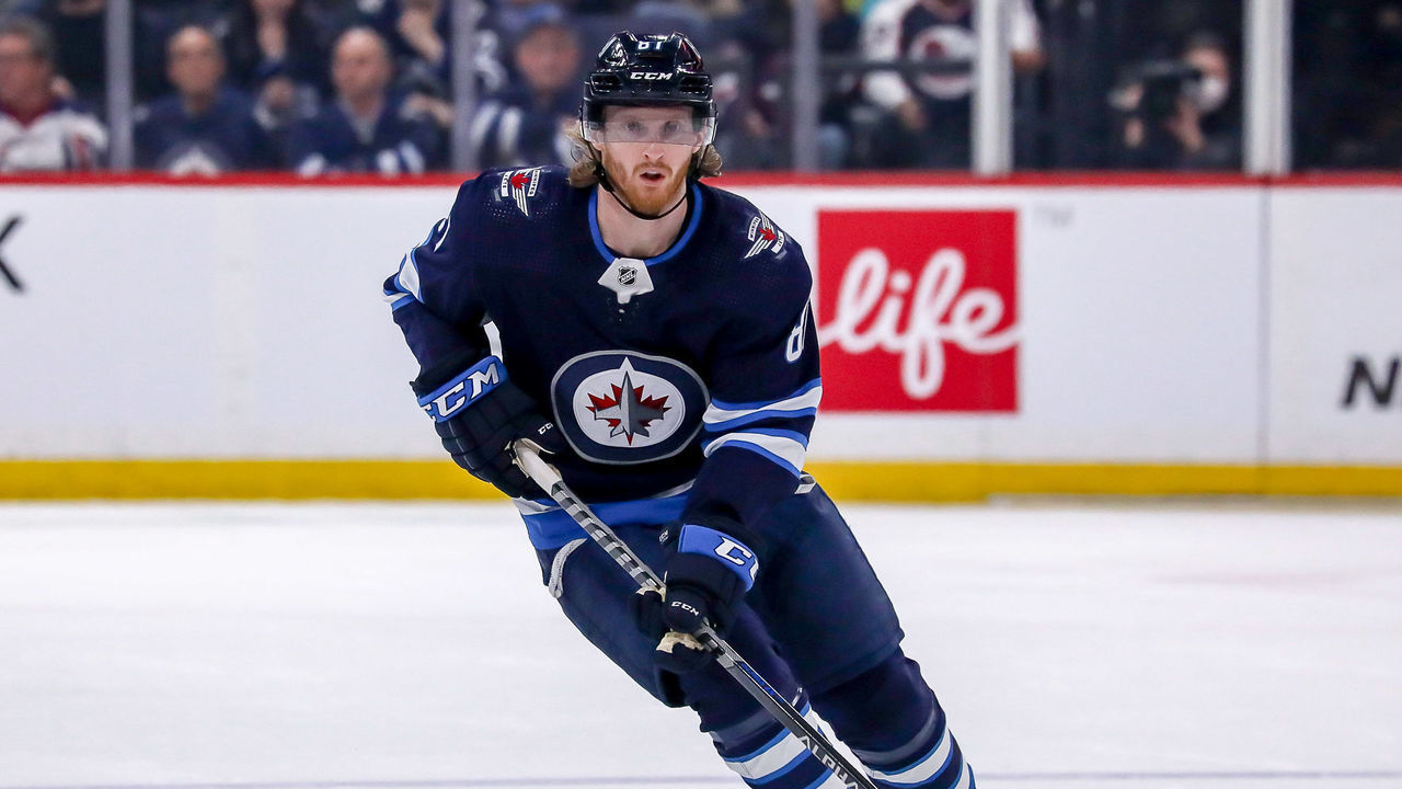 WINNIPEG, MB - MARCH 22: Kyle Connor #81 of the Winnipeg Jets plays the puck down the ice during first period action against the Vegas Golden Knights at the Canada Life Centre on March 22, 2022 in Winnipeg, Manitoba, Canada.