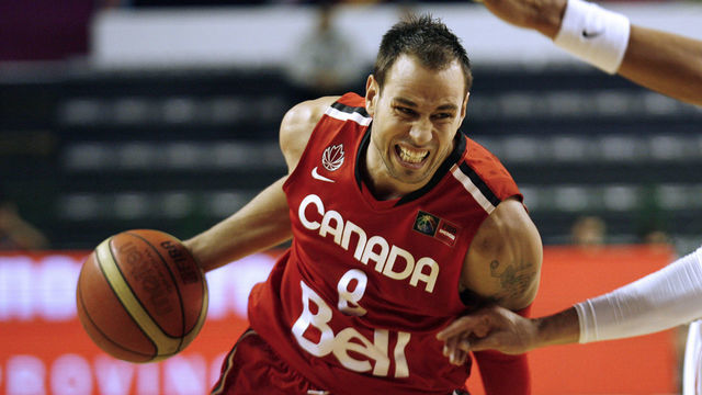 Carl English (L) of Canada takes the ball as Manuel Narvaez of Puerto Rico tries to block him during the qualifying round of the 2011 FIBA Americas Championship on September 6, 2011 at Islas Malvinas Stadium, Mar del Plata, Buenos Aires, Argentina. AFP PHOTO / Maxi FAILLA