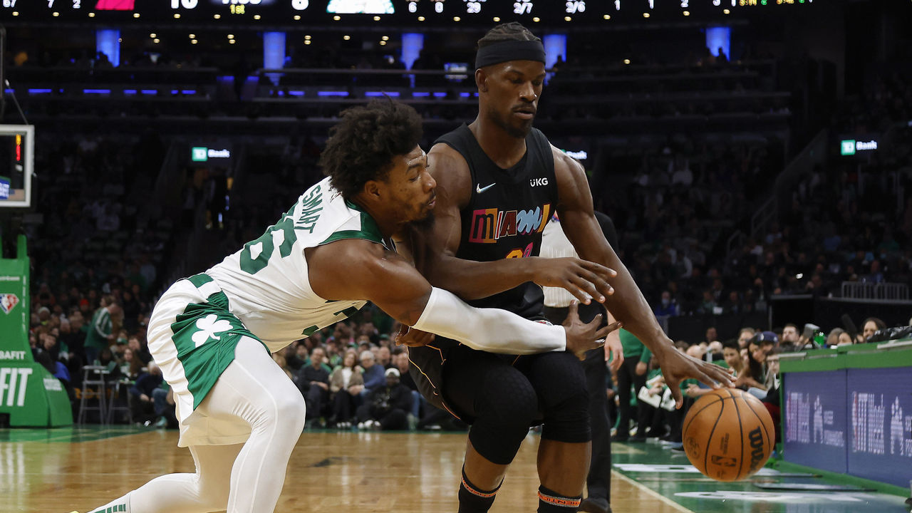 BOSTON, MA - MARCH 30: Marcus Smart #36 of the Boston Celtics reaches in to try to steal the ball from Jimmy Butler #22 of the Miami Heat during the first quarter at TD Garden on March 30, 2022 in Boston, Massachusetts. NOTE TO USER: User expressly acknowledges and agrees that, by downloading and/or using this Photograph, user is consenting to the terms and conditions of the Getty Images License Agreement.