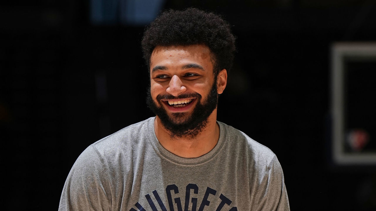 DENVER, CO - MARCH 22: Jamal Murray #27 of the Denver Nuggets warms up and smiles before the game against the LA Clippers on March 22, 2022 at the Ball Arena in Denver, Colorado. NOTE TO USER: User expressly acknowledges and agrees that, by downloading and/or using this Photograph, user is consenting to the terms and conditions of the Getty Images License Agreement. Mandatory Copyright Notice: Copyright 2022 NBAE