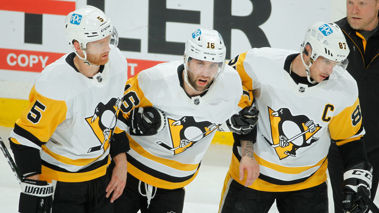 SAINT PAUL, MN - MARCH 31: Jason Zucker #16 is helped off of the ice by his teammates Mike Matheson #5 and Sidney Crosby #87 of the Pittsburgh Penguins after sustaining an injury during the game against the Minnesota Wild at the Xcel Energy Center on March 31, 2022 in Saint Paul, Minnesota.