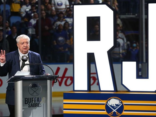 BUFFALO, NY - APRIL 1: Hall-of-Fame Buffalo Sabres play-by-play announcer Rick Jeanneret speaks as a banner bearing his name is added to the rafters of KeyBank Center in a ceremony prior to an NHL game against the Nashville Predators on April 1, 2022 at KeyBank Center in Buffalo, New York.