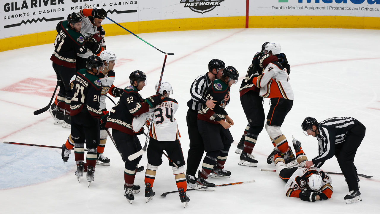 GLENDALE, ARIZONA - APRIL 01: Jay Beagle #83 of the Arizona Coyotes is held back by linesman Jonathan Deschamps #80 after a fight with Troy Terry #19 of the Anaheim Ducks during the third period of the NHL game at Gila River Arena on April 01, 2022 in Glendale, Arizona. The Ducks defeated the Coyotes 5-0.