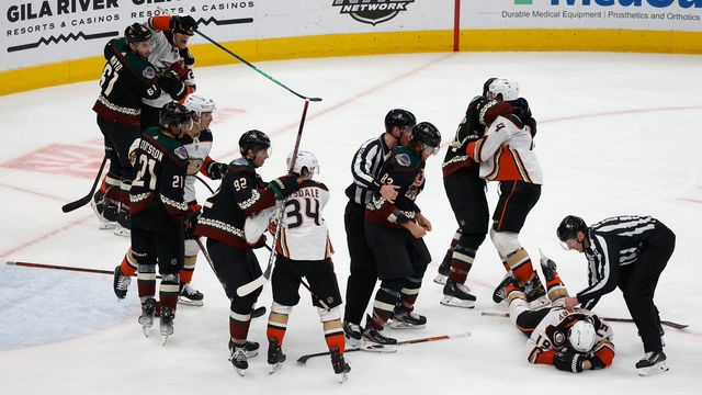 GLENDALE, ARIZONA - APRIL 01: Jay Beagle #83 of the Arizona Coyotes is held back by linesman Jonathan Deschamps #80 after a fight with Troy Terry #19 of the Anaheim Ducks during the third period of the NHL game at Gila River Arena on April 01, 2022 in Glendale, Arizona. The Ducks defeated the Coyotes 5-0.