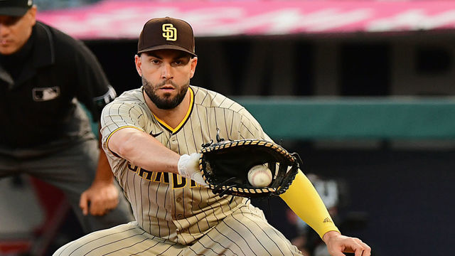 ANAHEIM, CA - AUGUST 27: San Diego Padres first baseman Eric Hosmer (30) takes a throw from pitcher while Los Angeles Angels third baseman Phil Gosselin (13) dives back safely during a game played on August 27, 2021 at Angel Stadium in Anaheim, CA.