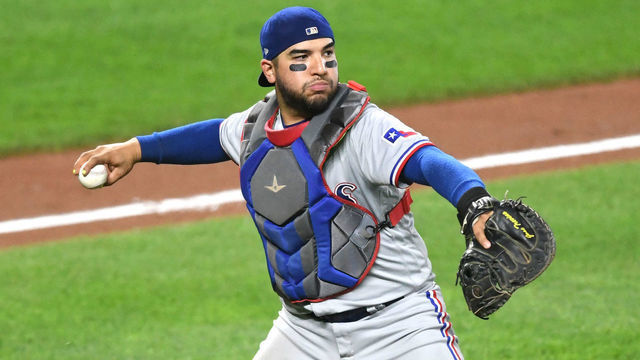 BALTIMORE, MD - SEPTEMBER 25: Jose Trevino #23 of the Texas Rangers fields a bunt during a baseball game against the Baltimore Orioles at Oriole Park at Camden Yards on September 25, 2021 in Baltimore, Maryland.