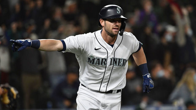 SEATTLE, WASHINGTON - SEPTEMBER 28: Mitch Haniger #17 of the Seattle Mariners gestures after hitting a solo home run during the seventh inning against the Oakland Athletics at T-Mobile Park on September 28, 2021 in Seattle, Washington.