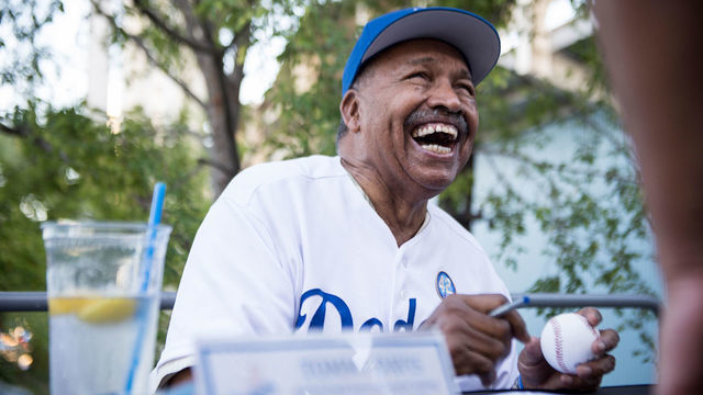 LOS ANGELES, CA - AUGUST 31: National batting league champion from the 1960s Tommy Davis signs autographs before the Los Angeles Dodgers defeated the San Francisco Giants 5-4 in the 14th inning Monday night at Dodger Stadium on August 31 in Los Angeles, CA