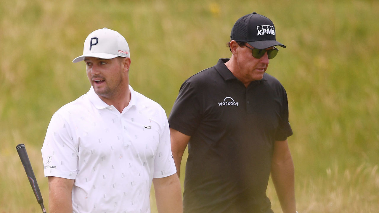 SANDWICH, ENGLAND - JULY 12: Bryson DeChambeau, Phil Mickelson of The United States and Nicholas Poppleton of England walk during a practice round for The 149th Open at Royal St George’s Golf Club on July 12, 2021 in Sandwich, England.