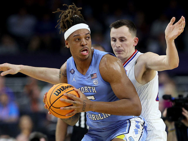NEW ORLEANS, LOUISIANA - APRIL 04: Armando Bacot #5 of the North Carolina Tar Heels looks to pass the ball as Mitch Lightfoot #44 of the Kansas Jayhawks defends in the first half of the game during the 2022 NCAA Men's Basketball Tournament National Championship at Caesars Superdome on April 04, 2022 in New Orleans, Louisiana.
