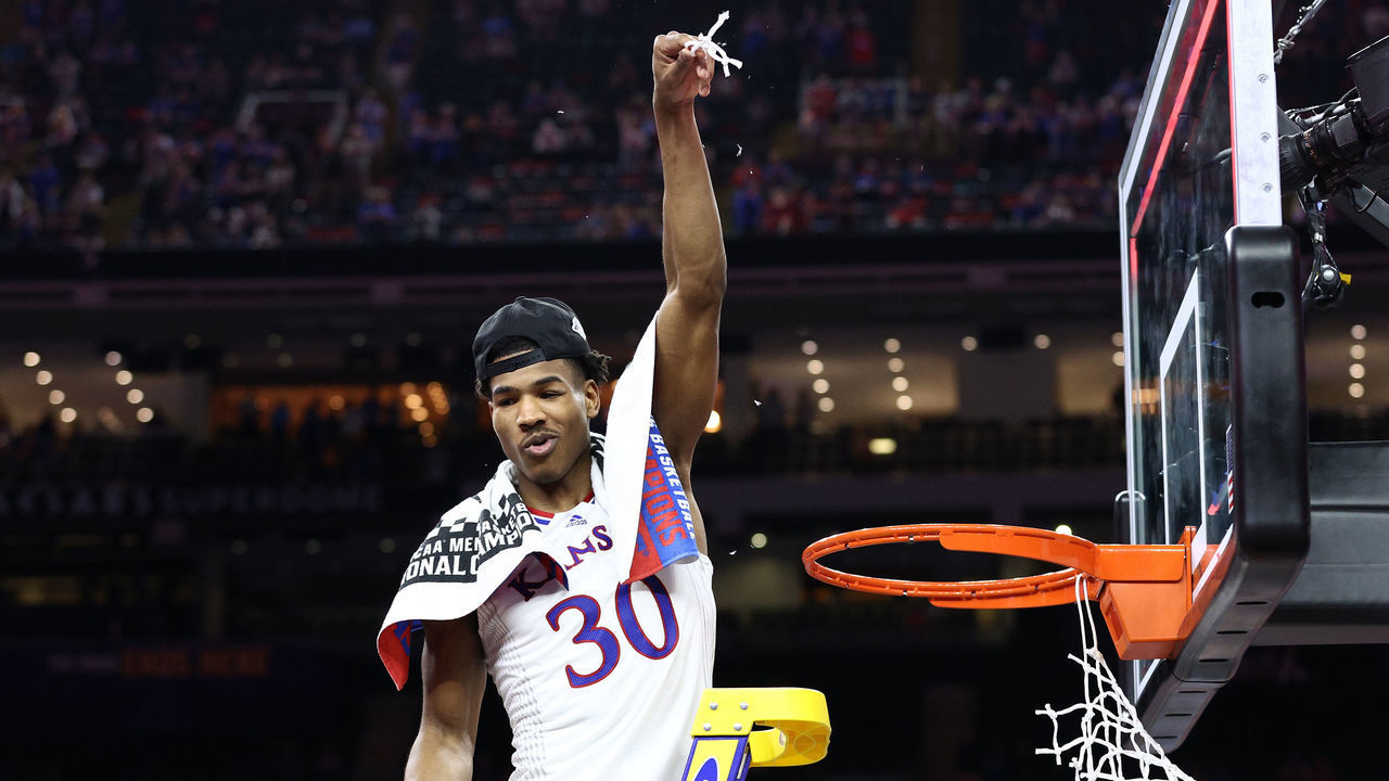 NEW ORLEANS, LOUISIANA - APRIL 04: Ochai Agbaji #30 of the Kansas Jayhawks cuts down the net after defeating the North Carolina Tar Heels 72-69 during the 2022 NCAA Men's Basketball Tournament National Championship at Caesars Superdome on April 04, 2022 in New Orleans, Louisiana.