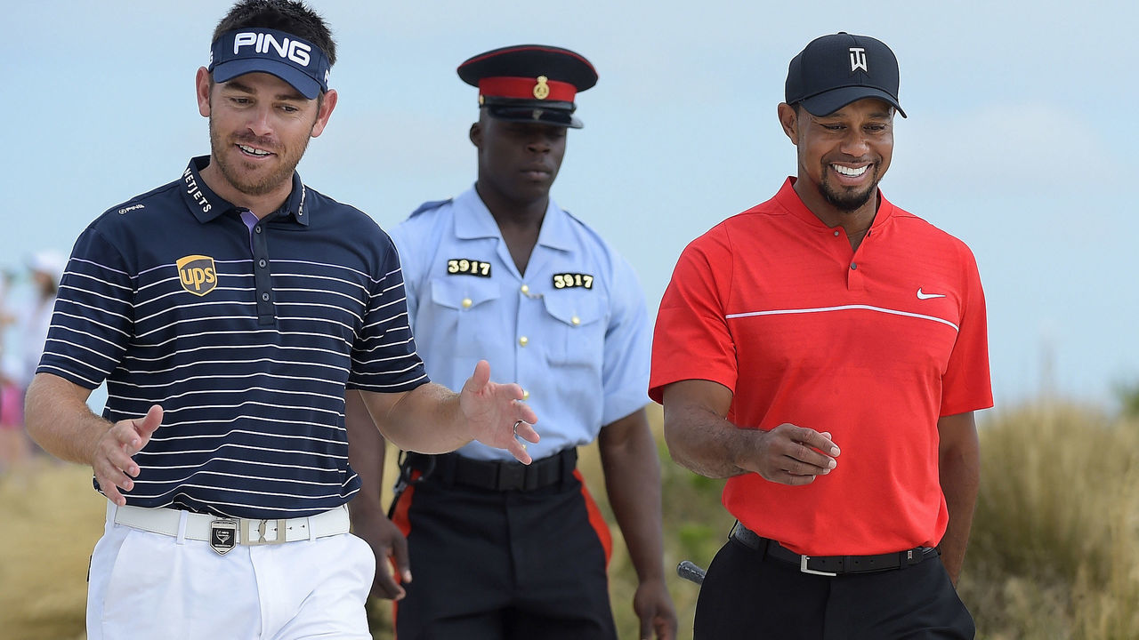 NASSAU, BAHAMAS - DECEMBER 04: (L-R) Louis Oosthuizen of South Africa and Tiger Woods walk along the seventh hole during the final round of the Hero World Challenge at Albany course on December 4, 2016 in Nassau, Bahamas.