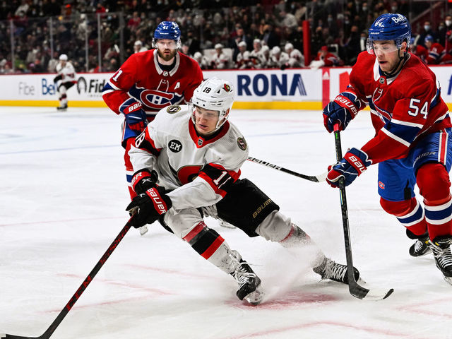 MONTREAL, QC - APRIL 05: Ottawa Senators left wing Tim Stutzle (18) plays the puck against Montreal Canadiens defenceman Jordan Harris (54) during the Ottawa Senators versus the Montreal Canadiens game on April 05, 2022 at Bell Centre in Montreal, QC