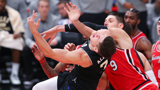 CHICAGO, IL - APRIL 05: Chicago Bulls center Nikola Vucevic (9) fouls Milwaukee Bucks guard Grayson Allen (7) during a NBA game between the Milwaukee Bucks and the Chicago Bulls on April 5, 2022 at the United Center in Chicago, IL.