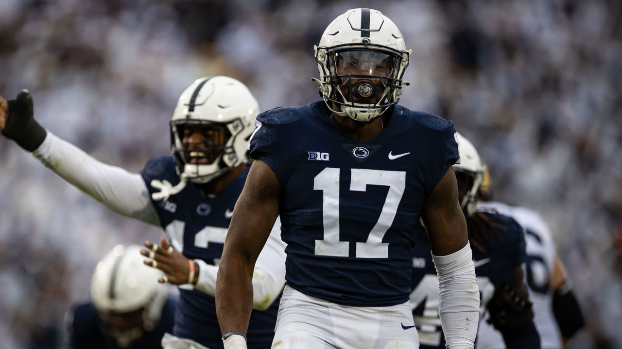 STATE COLLEGE, PA - NOVEMBER 13: Arnold Ebiketie #17 of the Penn State Nittany Lions celebrates with Ellis Brooks #13 after causing a fumble against the Michigan Wolverines during the second half at Beaver Stadium on November 13, 2021 in State College, Pennsylvania.