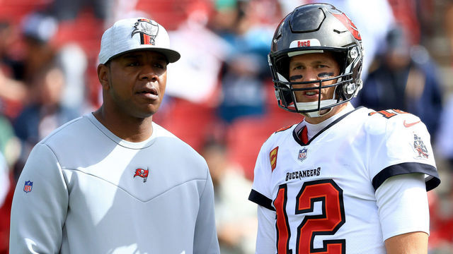 TAMPA, FLORIDA - JANUARY 16: Offensive Coordinator Byron Leftwich talks with Tom Brady #12 of the Tampa Bay Buccaneers prior to the NFC Wild Card Playoff game against the Philadelphia Eagles at Raymond James Stadium on January 16, 2022 in Tampa, Florida.