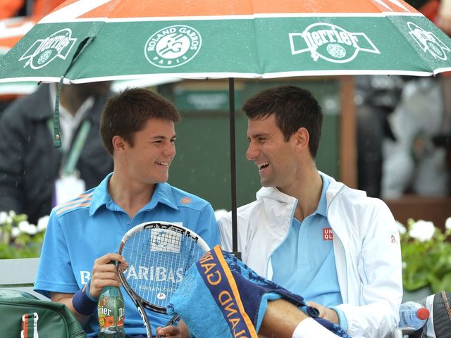 VIDEO: Novak Djokovic kicks it with a ball boy during a rain delay