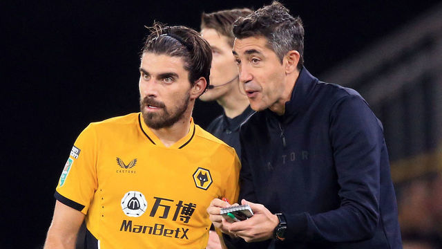 Wolverhampton Wanderers' Portuguese head coach Bruno Lage (R) speaks to Wolverhampton Wanderers' Portuguese midfielder Ruben Neves during the English League Cup third round football match between Wolverhampton Wanderers and Tottenham Hotspur at the Molineux stadium in Wolverhampton, central England on September 22, 2021. - RESTRICTED TO EDITORIAL USE. No use with unauthorized audio, video, data, fixture lists, club/league logos or 'live' services. Online in-match use limited to 120 images. An additional 40 images may be used in extra time. No video emulation. Social media in-match use limited to 120 images. An additional 40 images may be used in extra time. No use in betting publications, games or single club/league/player publications.