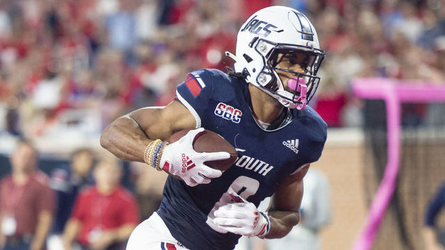 MOBILE, ALABAMA - OCTOBER 14: Wide receiver Jalen Tolbert #8 of the South Alabama Jaguars runs the ball in for a touchdown in front of cornerback Seth Robertson #20 of the Georgia Southern Eagles during the second quarter of play at Hancock Whitney Stadium on October 14, 2021 in Mobile, Alabama.