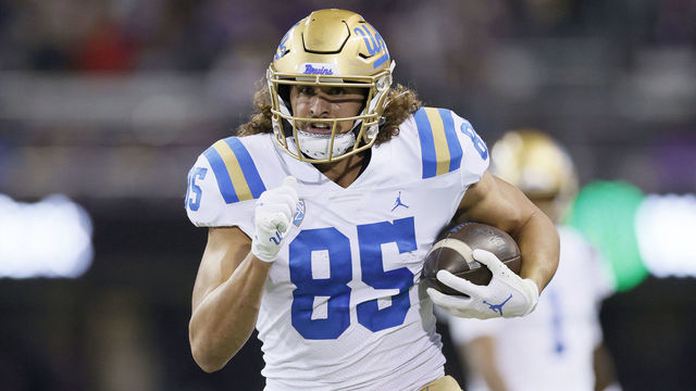 SEATTLE, WASHINGTON - OCTOBER 16: Greg Dulcich #85 of the UCLA Bruins carries the ball against the Washington Huskies during the fourth quarter at Husky Stadium on October 16, 2021 in Seattle, Washington.