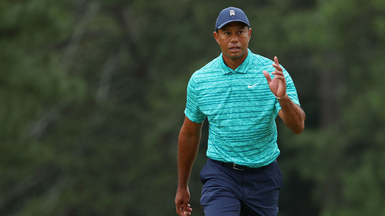 AUGUSTA, GEORGIA - APRIL 08: Tiger Woods waves to the crowd as he walks to the 18th green during the second round of The Masters at Augusta National Golf Club on April 08, 2022 in Augusta, Georgia.