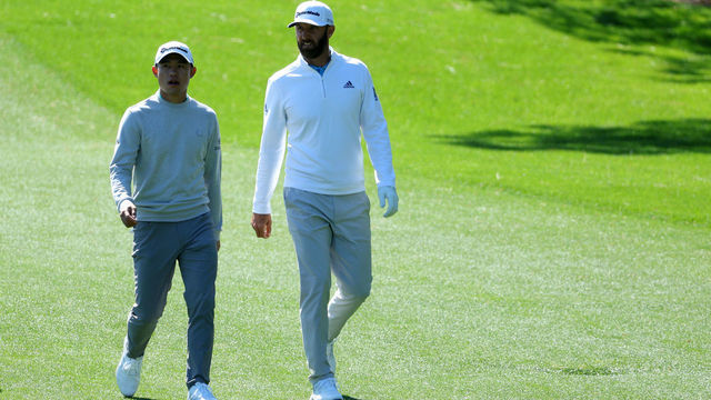 AUGUSTA, GEORGIA - APRIL 08: Collin Morikawa (L) and Dustin Johnson walk across the third hole during the second round of The Masters at Augusta National Golf Club on April 08, 2022 in Augusta, Georgia.