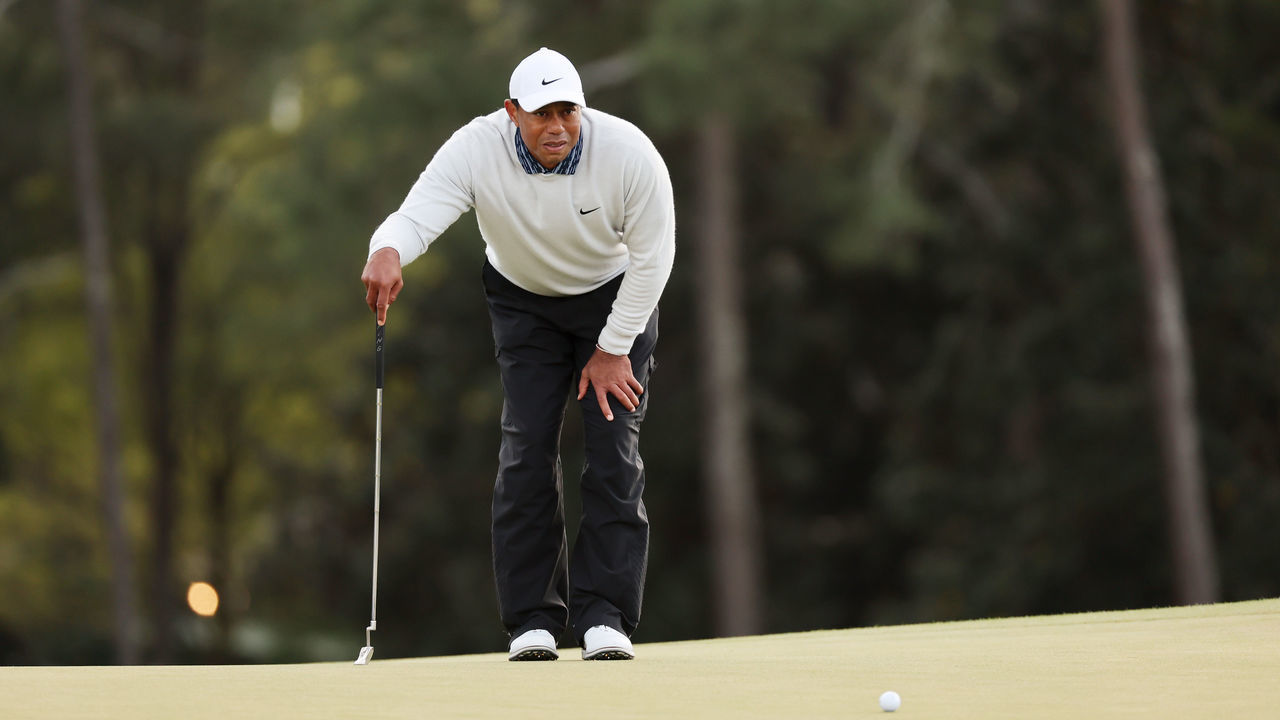 AUGUSTA, GEORGIA - APRIL 09: Tiger Woods lines up a putt on the 18th green during the third round of the Masters at Augusta National Golf Club on April 09, 2022 in Augusta, Georgia.