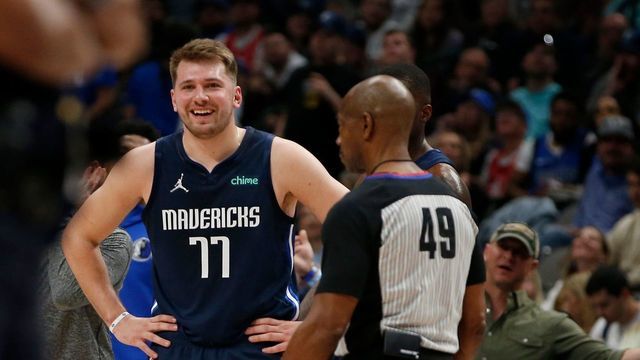 DALLAS, TEXAS - APRIL 08: Luka Doncic #77 of the Dallas Mavericks talks to referee Tom Washington #49 at the end of the first quarter of the game against the Portland Trail Blazers at American Airlines Center on March 27, 2022 in Dallas, Texas.