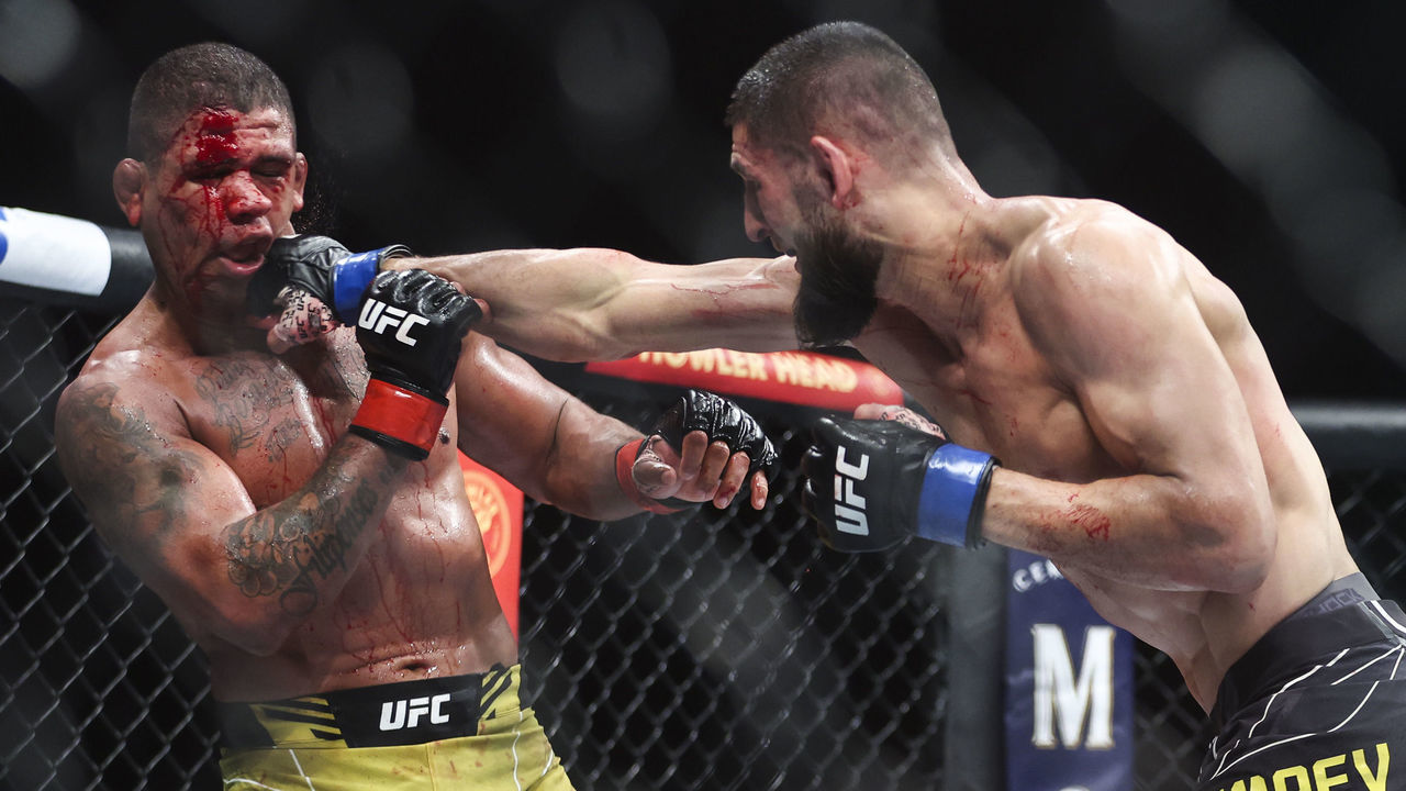 JACKSONVILLE, FLORIDA - APRIL 09: Khamzat Chimaev of Russia punches Gilbert Burns of Brazil in the welterweight bout during the UFC 273 event at VyStar Veterans Memorial Arena on April 09, 2022 in Jacksonville, Florida.