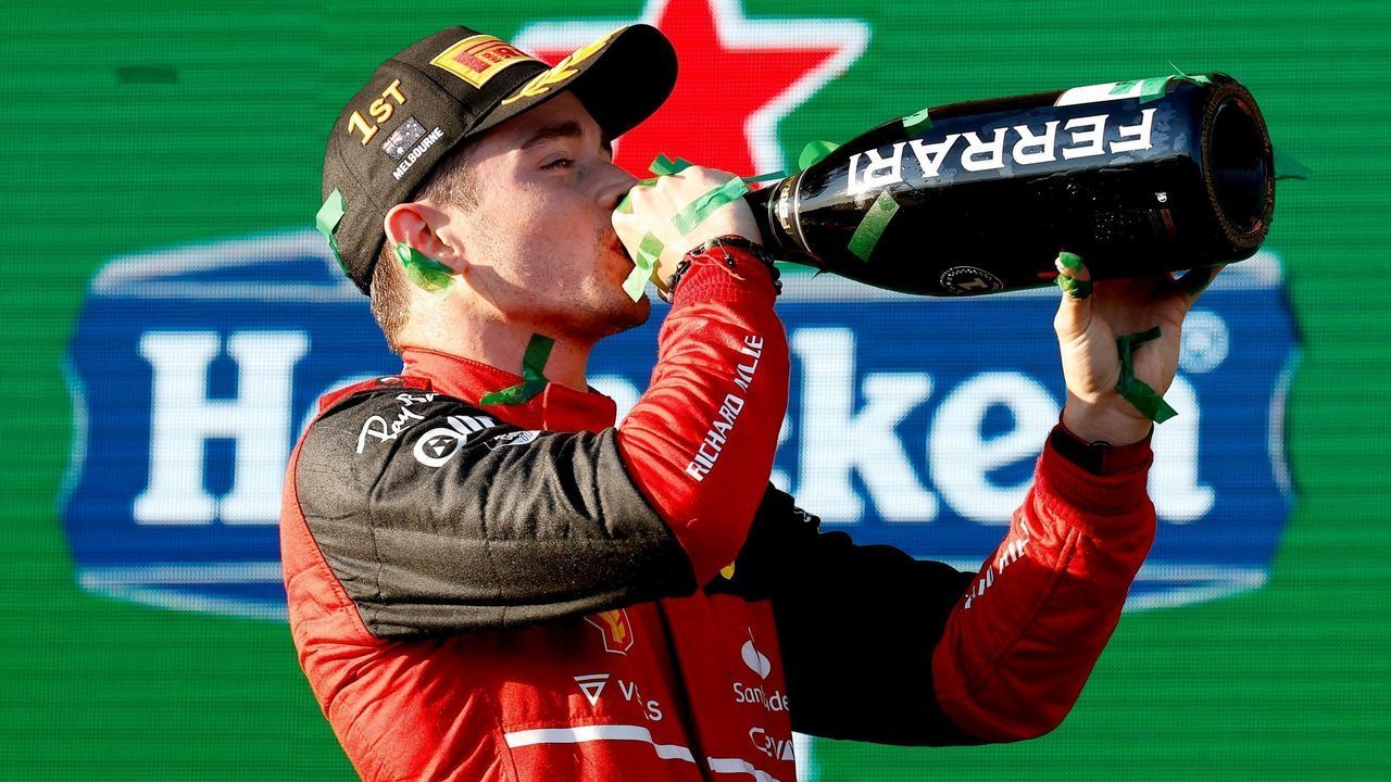 Ferrari's Monegasque driver Charles Leclerc celebrates his victory at the podium after the 2022 Formula One Australian Grand Prix at the Albert Park Circuit in Melbourne on April 10, 2022. - -- IMAGE RESTRICTED TO EDITORIAL USE - STRICTLY NO COMMERCIAL USE --