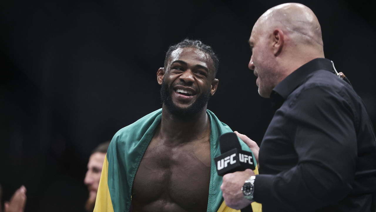 JACKSONVILLE, FLORIDA - APRIL 09: Aljamain Sterling talks with Joe Rogan after his UFC bantamweight championship fight against Petr Yan of Russia during the UFC 273 event at VyStar Veterans Memorial Arena on April 09, 2022 in Jacksonville, Florida.
