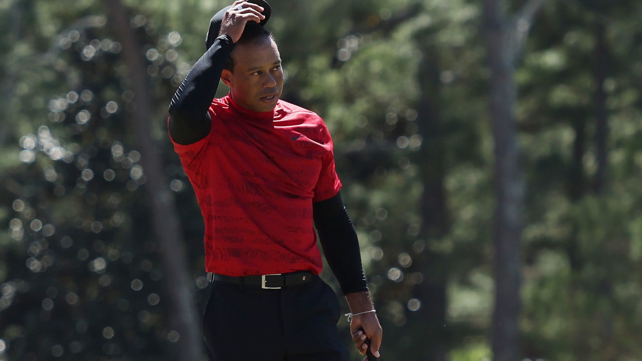 AUGUSTA, GEORGIA - APRIL 10: Tiger Woods tips his hat to the crowd on the 18th green after finishing his round during the final round of the Masters at Augusta National Golf Club on April 10, 2022 in Augusta, Georgia.