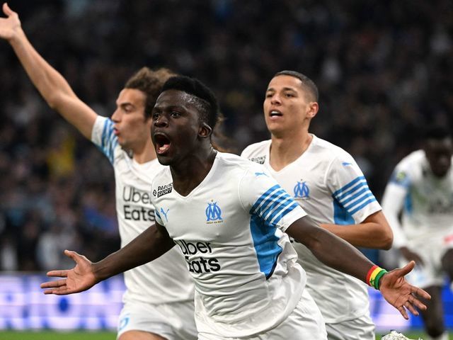 Marseille's Senegalese forward Bamba Dieng celebrates scoring his team's first goal during the French L1 football match between Olympique de Marseille (OM) and SC Montpellier at the Velodrome Stadium in Marseille, southern France, on April 10, 2022.