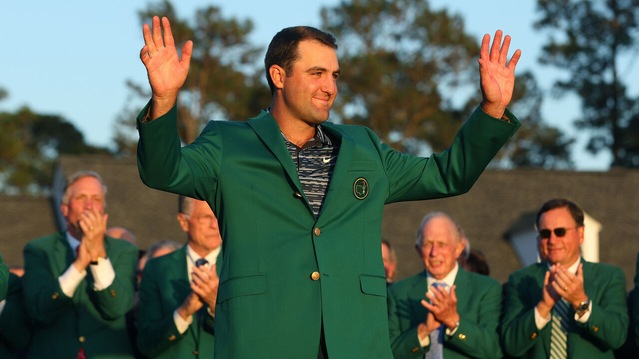 AUGUSTA, GEORGIA - APRIL 10: Scottie Scheffler celebrates after being awarded the Green Jacket during the Green Jacket Ceremony after winning the Masters at Augusta National Golf Club on April 10, 2022 in Augusta, Georgia.