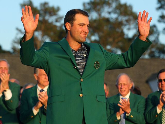 AUGUSTA, GEORGIA - APRIL 10: Scottie Scheffler celebrates after being awarded the Green Jacket during the Green Jacket Ceremony after winning the Masters at Augusta National Golf Club on April 10, 2022 in Augusta, Georgia.