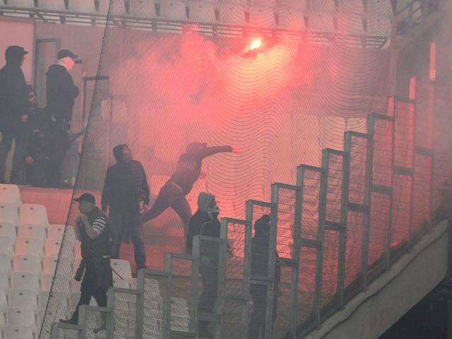 PAOK supporters throw burning flares from the stands priorto the UEFA Europa Conference League quarter-final second leg football match between Olympique de Marseille (OM) and PAOK Thessaloniki at the Velodrome Stadium in Marseille, southeastern France on April 7, 2022.