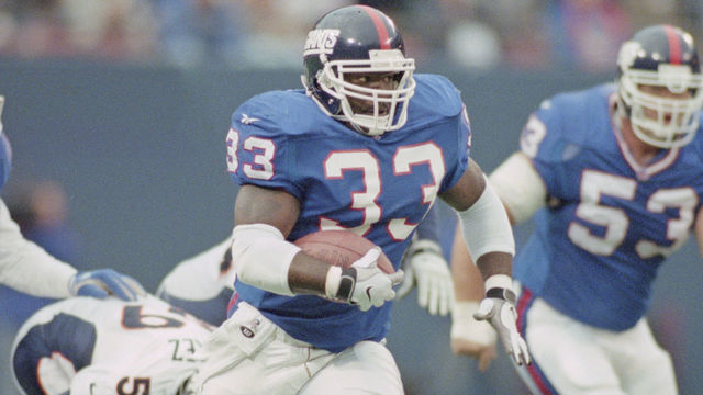 Gary Brown #33, Running Back for the New York Giants runs the ball during the National Football Conference East game against the Denver Broncos on 13 December 1998 at the Giants Stadium, East Rutherford, New Jersey, United States. The Giants won 20 - 16 .