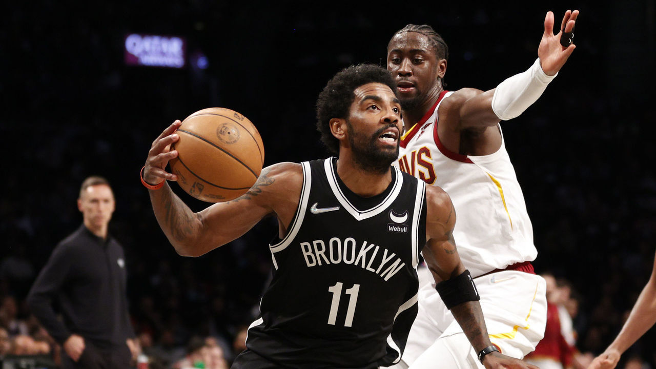 NEW YORK, NEW YORK - APRIL 12: Kyrie Irving #11 of the Brooklyn Nets dribbles as Caris LeVert #3 of the Cleveland Cavaliers defends during the first half of the Eastern Conference 2022 Play-In Tournament at Barclays Center on April 12, 2022 in the Brooklyn borough of New York City.